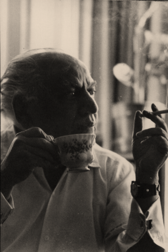 Poet Faiz Ahmad Faiz with a cup of tea and cigarette